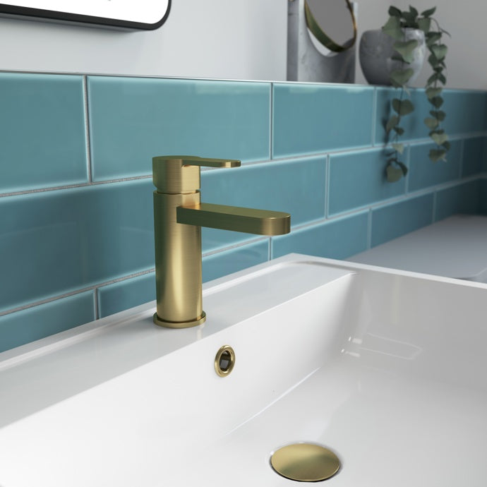Gold faucet on a white sink 