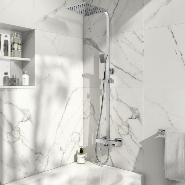 Modern shower setup with marble walls and a shelf in a bathroom.