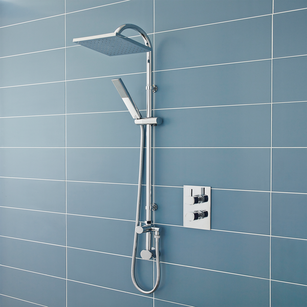 Chrome shower system mounted on a blue tiled wall