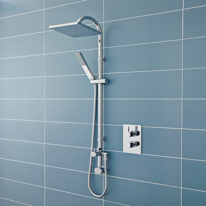 Chrome shower system mounted on a blue tiled wall