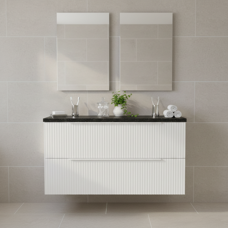 Hudson Reed white fluted wall-hung 2 drawer vanity unit with black marble worktop styled with soap dishes, toothbrush holders, plant and rolled towels - no basin