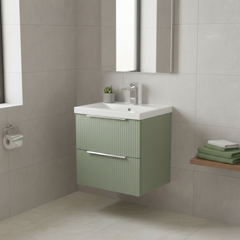 Hudson Reed sage green ribbed wall-hung 2 drawer vanity unit with integrated ceramic basin and chrome tap styled in a bright designer bathroom with light grey tiles and natural daylight