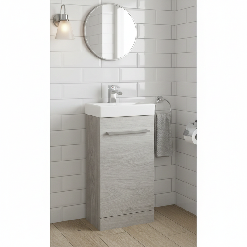 Silver birch wood-effect floor standing cloakroom vanity unit with single door and ceramic basin styled in an elegant cloakroom with metro tiles and chrome accessories